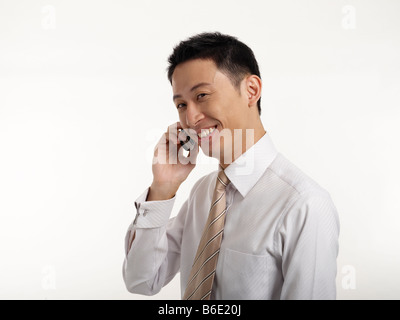 Businessman using mobile phone, smiling Stock Photo