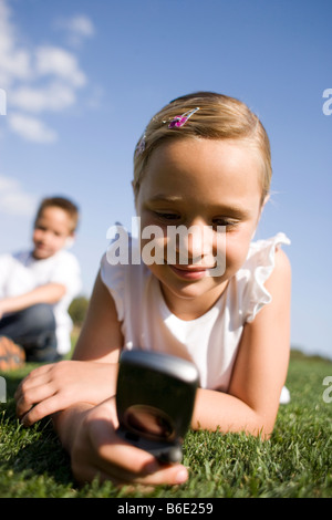 Girl using a mobile telephone. Mobile telephonessend and receive voice and text data aslow-intensity microwaves. Stock Photo