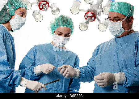Surgeons performing an operation. Stock Photo