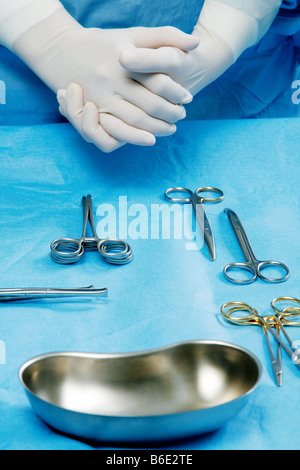Surgical tools being laid out byan assistant in an operating theatre Stock Photo