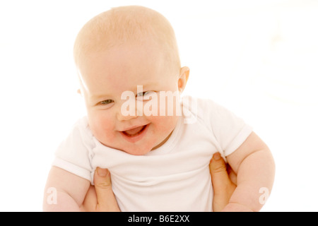 Baby girl being lifted Stock Photo