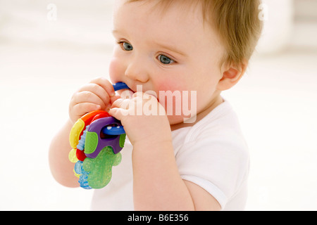 Baby boy chewing on teething ring Stock Photo