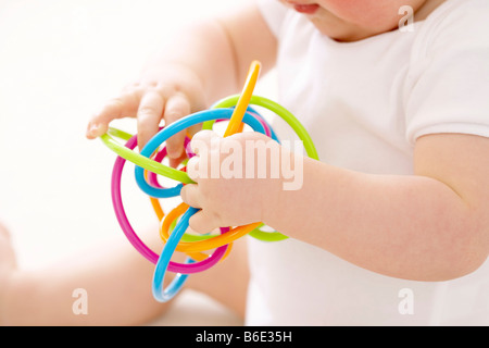 Baby boy playing with teething ring Stock Photo