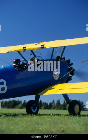 Old american trainer biplane Boeing PT-17 Kaydet / Stearman model 75 starting radial engine and ready to departure Stock Photo