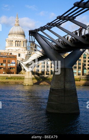 Saint Pauls Cathedral from across the River Thames in London showing the Millenium walk bridge and Westminster School in London. Stock Photo