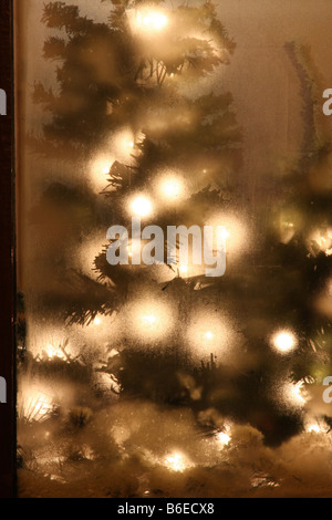 Christmas decorations in a store window that has steamed up from the cold outside Stock Photo