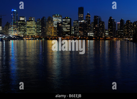Vancouver skyline cityscape at twilight reflected in Burrard Inlet from Stanley Park Stock Photo