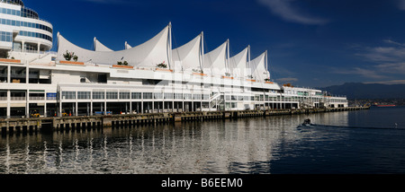 Panorama of Canada Place pier and sails with North Vancouver Coastal mountains and cargo ship Stock Photo