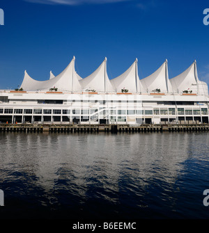 Canada Place sails against blue sky in Vancouver reflected in the blue water of Burrard Inlet Pacific ocean British Columbia Canada Stock Photo