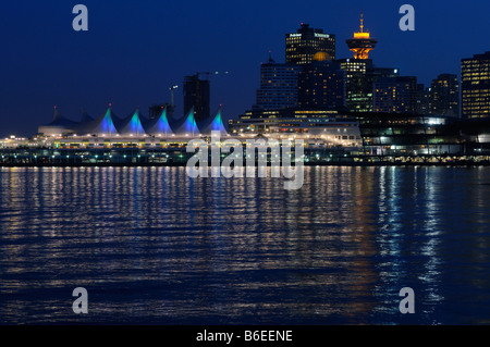 Downtown Vancouver and Canada Place at twilight with city lights reflected in Burrard Inlet British Columbia Canada Stock Photo