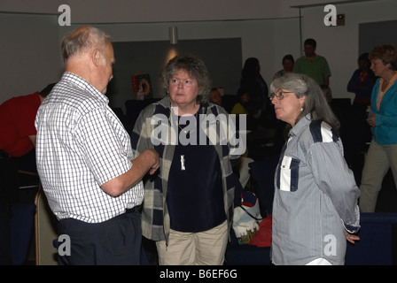 Older man talking to two older women Stock Photo