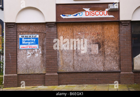 Closed and boarded up shop for sale or to let on main street of Pontypool Torfaen South Wales UK Stock Photo