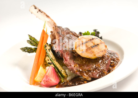 Veal chop with grilled pear and seasonal vegetables Stock Photo