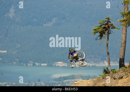 Mountain Biker doing a table over a hip jump Stock Photo