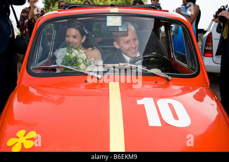 Newlyweds in a red Fiat 500 Italy Stock Photo