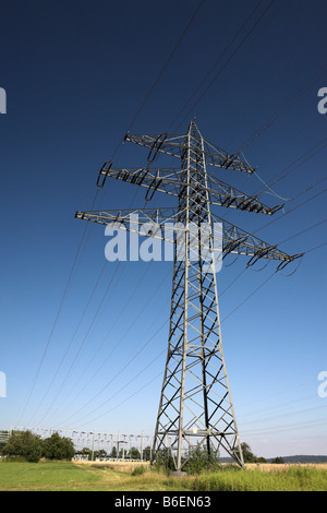 Pylon for high voltage electric cables reaching into a blue sky near Birkenfeld, Black Forest, Baden-Wuerttemberg, Germany, Eur Stock Photo