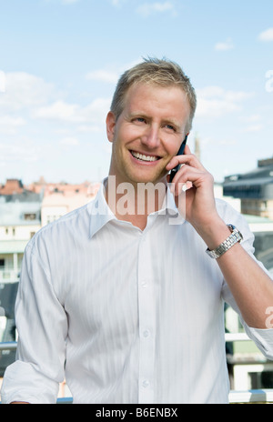 Guy on a balcony with cellphone Stock Photo