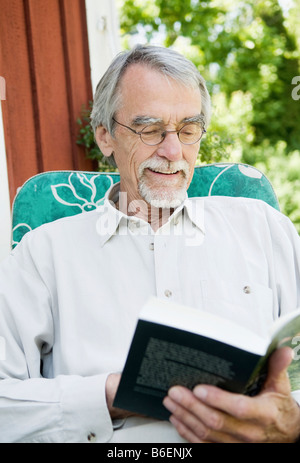 Man reading a book outdoor Stock Photo