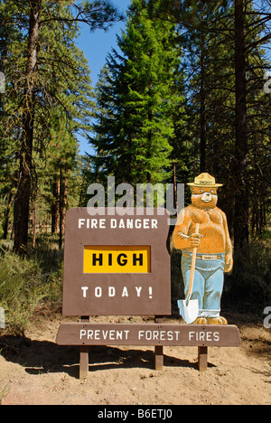 Smokey Bear on a High Fire Danger warning sign in the National Forest, Oregon, USA Stock Photo