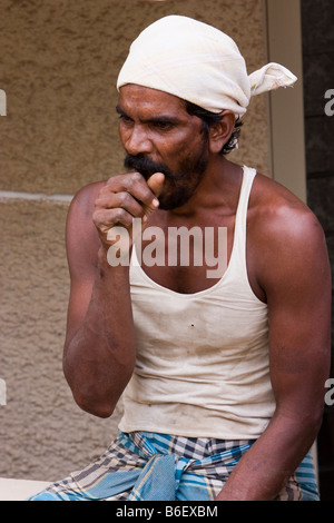 A bored construction worker in Tamil Nadu, India. Stock Photo