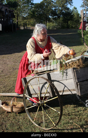 A woman collecting her vegetables from her vegetable wagon taking items to town or market in the old west Stock Photo