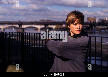 Young woman stretching before running Stock Photo