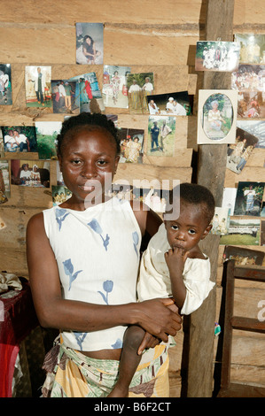 AIDS/HIV positive woman with child, portrait, in her flat, Manyemen, Cameroon, Africa