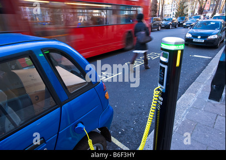 G Wiz electric car is being charged up from a City of Westminster Juice Point London United Kingdom Stock Photo