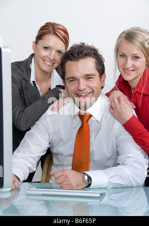 three happy businesspeople in office Stock Photo