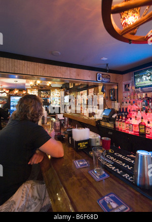 Man watching football on ESPN on TV in a bar just off Duval Street, Old Town, Key West, Florida Keys, USA Stock Photo