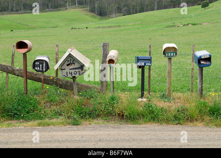 Post boxes of different farmhouses on the side of a road near Deloraine, Tasmania, Australia Stock Photo