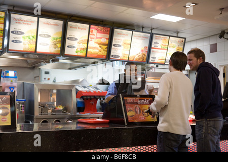 People ordering food in a Wimpy restaurant, M25 service station, Surrey, England Stock Photo