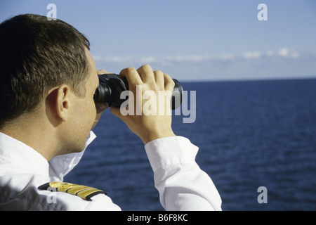 officer looking through binoculars Stock Photo