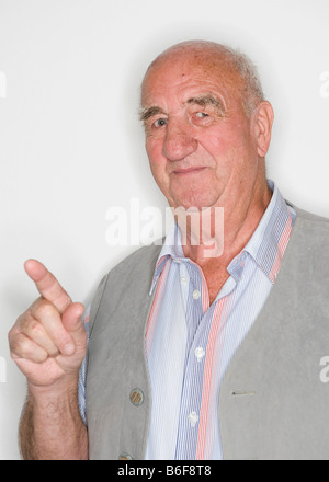 Elderly man acting, stretched out index finger Stock Photo