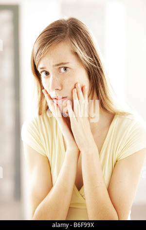 Girl, 17, looking scared Stock Photo