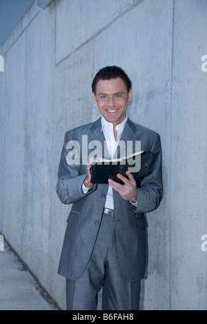 Man wearing a business suit making notes Stock Photo