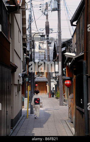 A Maiko, a trainee Geisha, walking in an alley in the Gion Quarter of Kyoto, Japan, Asia Stock Photo
