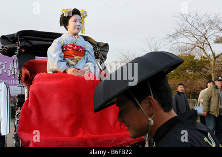 A Maiko, a trainee Geisha, sitting in a rickshaw, Kyoto, Japan, Asia Stock Photo