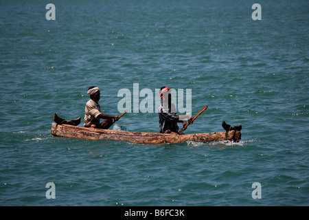 Two fishermen sailing a canoe for fishing purpose Stock Photo