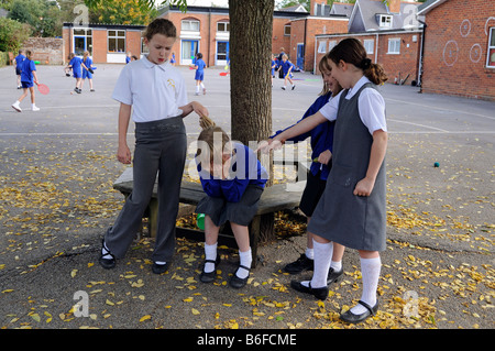 School playground schoolgirl being bullied by classmates Stock Photo