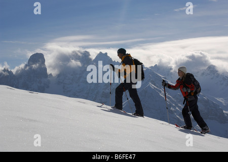 Snowshoe hikers on the Plaetzwiese Meadow in front of the Monte Cristallo Massif, High Puster Valley or Alto Pusteria, Bolzano- Stock Photo