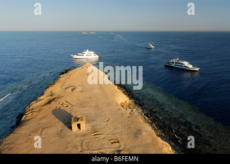 View from lighthouse over barren island onto the ocean to dive boats and reef, top dive location, Big Brother of The Brothers I Stock Photo