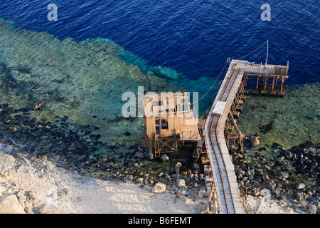 View from lighthouse over barren rocks and pier onto the ocean and reef, top dive location, Big Brother of The Brothers Islands Stock Photo