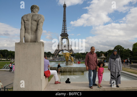 Immigrant family posing in front of the Eiffel Tower, Paris, France, Europe Stock Photo