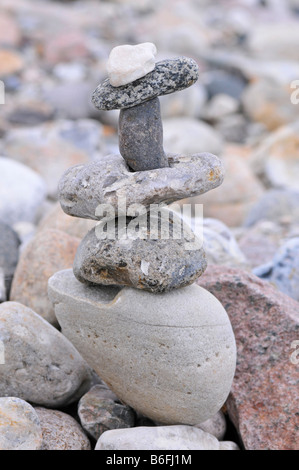 Pebbles stacked in a cairn on the beach Stock Photo