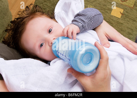 Feeding baby boy, 4 months, with bottle Stock Photo
