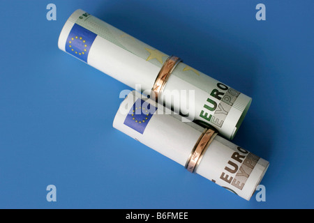 Euro-bills and wedding rings Stock Photo