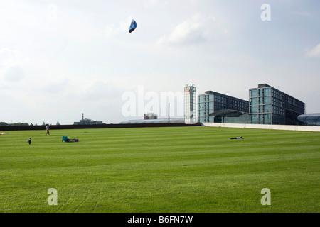 People on a meadow flying kites in front of the central station of Berlin, Germany, Europe Stock Photo