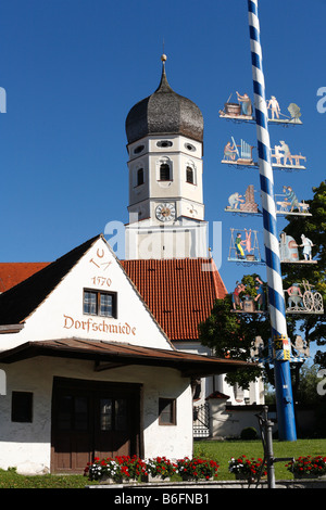 Village smithy, church and maypole in Erling, Andechs municipality, Fuenfseenland, Upper Bavaria, Germany, Europe Stock Photo