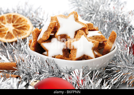 Cinnamon flavored star-shaped biscuits, christmas decorations, Cinnamon sticks, slices of orange and christmas tree balls Stock Photo